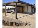 Covered carport and cozy home featuring low maintenance desert landscaping at 10951 N 91St Ave # 255, Peoria, AZ 85345