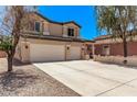 Attractive two-story home showcasing a wide driveway and a neatly maintained front yard at 12375 W Meadowbrook Ave, Avondale, AZ 85392