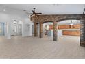 Expansive living area featuring tile flooring, archways, and a stunning stone accent wall at 13630 W Redfield Rd, Surprise, AZ 85379