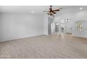 Open-concept living room showcasing stylish tiled flooring and bright, neutral wall color at 13630 W Redfield Rd, Surprise, AZ 85379