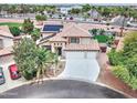 Beautiful two-story home featuring a well-manicured lawn, desert landscaping, and a wide driveway leading to a spacious three-car garage at 16197 N 157Th Ave, Surprise, AZ 85374