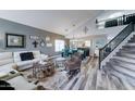 Stylish living room featuring soaring ceilings, modern furniture, and a staircase leading to the second floor, perfect for entertaining at 16197 N 157Th Ave, Surprise, AZ 85374