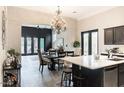 Open-concept kitchen connected to a dining area, featuring an island with bar stools at 1659 N Channing --, Mesa, AZ 85207