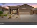 Charming single-story home featuring desert landscaping, a two-car garage and neutral exterior paint at 18434 E El Buho Pequeno Rd, Gold Canyon, AZ 85118