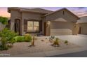 Charming single-story home featuring desert landscaping, a two-car garage and neutral exterior paint at 18434 E El Buho Pequeno Rd, Gold Canyon, AZ 85118