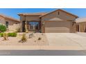 Charming single-story home featuring desert landscaping, a two-car garage and neutral exterior paint at 18434 E El Buho Pequeno Rd, Gold Canyon, AZ 85118