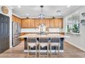 Open kitchen featuring a large island with granite countertops and stainless steel appliances at 1974 E Dubois Ave, Gilbert, AZ 85298