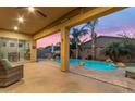 Covered patio opens to a refreshing pool area with rock accents and tropical landscaping at 22639 E Avenida Del Valle --, Queen Creek, AZ 85142