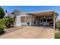 Inviting single-story home with a covered carport and well-maintained landscaping, offering comfort and convenience at 2400 E Baseline Ave # 169, Apache Junction, AZ 85119