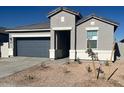 Single-story home featuring a manicured lawn, neutral paint scheme, and a two-car garage in a residential community at 25484 W Graham Trl, Buckeye, AZ 85326
