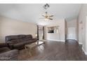 Open-concept living room with vaulted ceiling and updated wood-look tile flooring at 30100 N Sunray Dr, San Tan Valley, AZ 85143