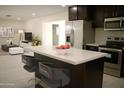 Modern kitchen features a large island with seating, stainless steel appliances, and sleek countertops at 3208 W Bloomfield Rd, Phoenix, AZ 85029