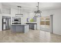 Modern kitchen with a large island, stainless steel appliances, gray cabinetry, and tile floors, perfect for cooking and entertaining at 3843 E Citrine Rd, San Tan Valley, AZ 85143