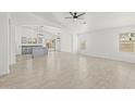 Bright and airy living space features neutral paint, tile floors, contemporary lighting, and seamless flow into the kitchen at 3843 E Citrine Rd, San Tan Valley, AZ 85143