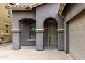 Inviting front entrance with a covered porch, brick pavers, and elegant architectural details at 3952 E Frances Ln, Gilbert, AZ 85295