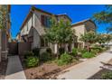 Charming home showcasing manicured landscaping with lush green shrubs and mature trees at 4044 S 58Th Ln, Phoenix, AZ 85043
