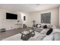 Bright living room featuring a plush sectional sofa and a modern glass coffee table at 4044 S 58Th Ln, Phoenix, AZ 85043