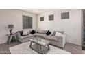 Comfortable living room showcasing a cozy sectional sofa with throw pillows and modern decor at 4044 S 58Th Ln, Phoenix, AZ 85043