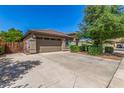Single-Gathering home featuring a two-car garage and a spacious driveway at 44158 W Canyon Creek Dr, Maricopa, AZ 85139
