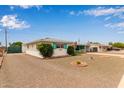 Single-story home featuring a low-maintenance front yard and a tent to cover a car at 5317 E Colby St, Mesa, AZ 85205