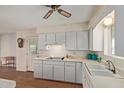 Bright kitchen featuring white cabinets, laminate counters, and ample storage space at 5317 E Colby St, Mesa, AZ 85205