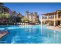 Inviting community pool with ample seating and palm trees at 5350 E Deer Valley Dr # 3267, Phoenix, AZ 85054