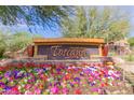 Community signage amidst vibrant flowers and lush greenery at 5350 E Deer Valley Dr # 3267, Phoenix, AZ 85054