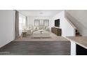 Bright living room featuring neutral colors, carpet, and stairs at 5826 W Sunrise Dr, Laveen, AZ 85339