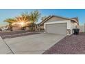 Exterior view of home showing driveway leading to two-car garage with desert landscaping at 6244 E Inglewood St, Mesa, AZ 85205