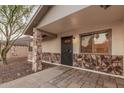 Front porch view with stone accents, window and door at 6244 E Inglewood St, Mesa, AZ 85205