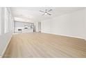 Open-concept living space with wood-look floors, neutral walls, and a ceiling fan at 651 W Laredo St, Chandler, AZ 85225