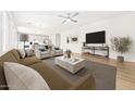 Bright, open-concept living room with modern furnishings and hardwood floors flowing into an adjacent kitchen at 651 W Laredo St, Chandler, AZ 85225
