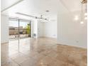 Spacious living room with travertine flooring and large glass doors to the balcony at 7157 E Rancho Vista Dr # 5004, Scottsdale, AZ 85251