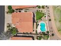 Aerial view of a house with a backyard pool, lush greenery, and a well-maintained roof at 7464 E Lompoc Ave, Mesa, AZ 85209