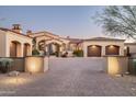 Beautifully landscaped property featuring a red tile roof, stucco exterior, and a spacious driveway at 7753 E Whisper Rock Trl, Scottsdale, AZ 85266