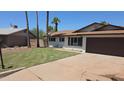 Charming single-story home with freshly cut lawn, mature trees, and an attached two-car garage at 8146 N 17Th Dr, Phoenix, AZ 85021