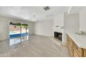 Spacious living area with tile flooring, fireplace, and sliding glass doors leading to the pool at 8146 N 17Th Dr, Phoenix, AZ 85021