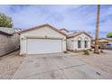 Inviting single story home with a two car garage, desert landscaping and an arched entryway at 8404 W Coronado Rd, Phoenix, AZ 85037