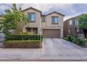 A traditional two-story home with neutral stucco exterior, a two-car garage, and neatly trimmed front bushes at 8905 W Jefferson St, Tolleson, AZ 85353