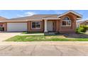Charming home featuring a welcoming front yard, two-car garage, and decorative pillars at the entrance at 915 E Annette Dr, Phoenix, AZ 85022