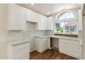 Updated kitchen with stylish white cabinetry, granite countertops, and contemporary backsplash at 915 E Annette Dr, Phoenix, AZ 85022