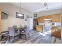 Eat-in kitchen featuring wood cabinets, modern appliances, and a cozy dining area at 12046 W Flores Dr, El Mirage, AZ 85335