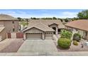 Beautiful home exterior showcasing a well-maintained lawn, three-car garage, and appealing architectural design at 12214 W Madison St, Avondale, AZ 85323