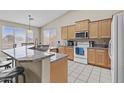 Bright kitchen boasts a breakfast bar, modern appliances, and ample cabinet space at 12214 W Madison St, Avondale, AZ 85323