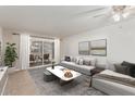Bright living room with sliding glass doors to patio and neutral decor at 131 N Higley Rd # 117, Mesa, AZ 85205