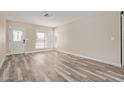 Bright and spacious living room featuring modern wood-look floors and ample natural light at 1416 W Highland St, Chandler, AZ 85224