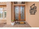 Elegant double front doors with decorative glass, a welcome mat, and stylish exterior details at 1667 E Saltsage Dr, Phoenix, AZ 85048