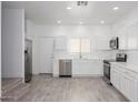 Modern kitchen features stainless steel appliances, white cabinets, and quartz countertops at 17610 N 17Th Pl # 2, Phoenix, AZ 85022
