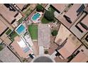 Bird's-eye view of a home with backyard pool, patio, manicured lawn, and desert landscaping at 18351 W Southgate Ave, Goodyear, AZ 85338