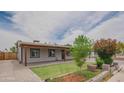 Charming single-story home showcasing a well-manicured front yard, covered patio, and inviting curb appeal at 1861 N 63Rd Ave, Phoenix, AZ 85035